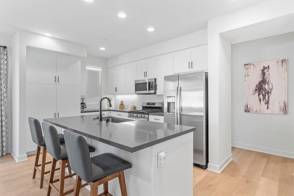 Bar height seating is available for three from the kitchen Island.