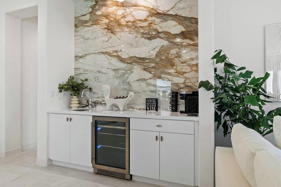 Start your morning with coffee at the built-in bar beneath stunning stone details.