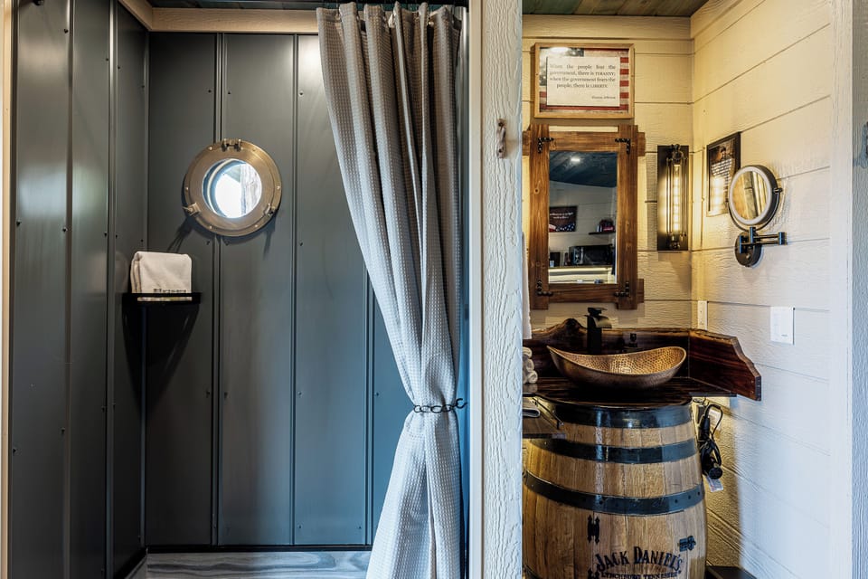JACK DANIEL'S WHISKEY BARREL SINK - CUSTOM TILE RAIN SHOWERS - PORT HOLE WINDOWS - JACK DANIEL'S CUSTOM VANITY SINKS - MAGNIFYING MIRROR - HAIR DRYER - CUSTOM SINK - MAKE UP TOWEL - LUXURY LINENS & TOILETRIES PROVIDED