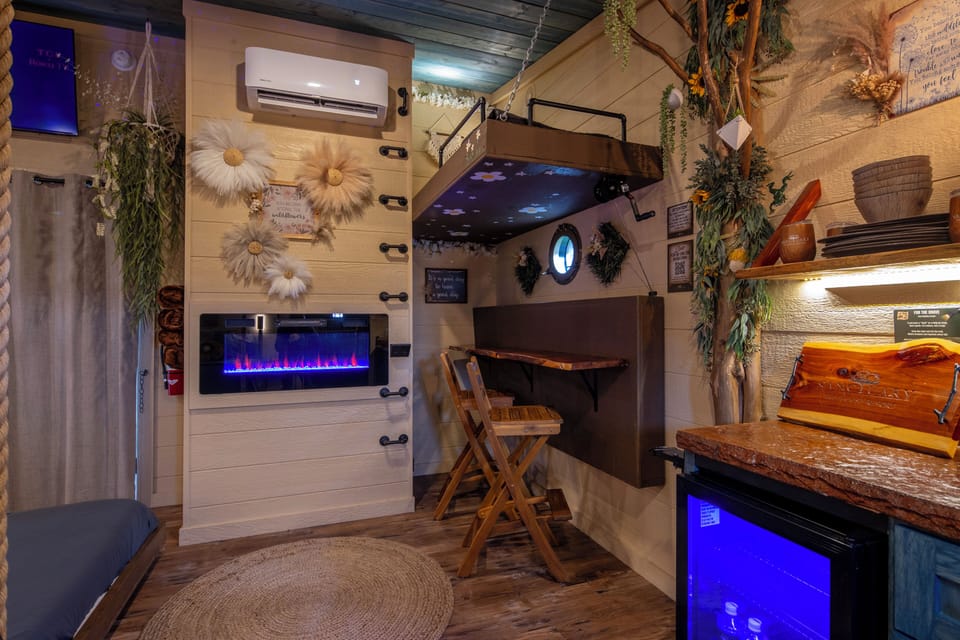 CRANK THE LOWER BUNK UP TO REVEAL A TABLE TOP AND BAR STOOL SEATS FOR TWO FOR EXTRA DINING OR WORK SPACE