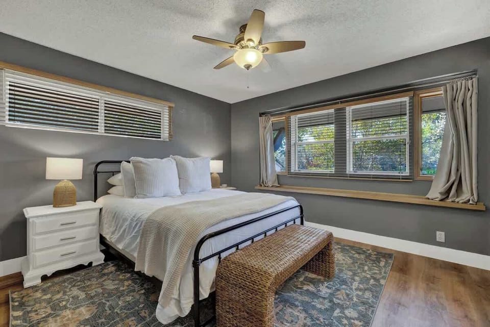 Main house bedroom two boasts a queen bed.