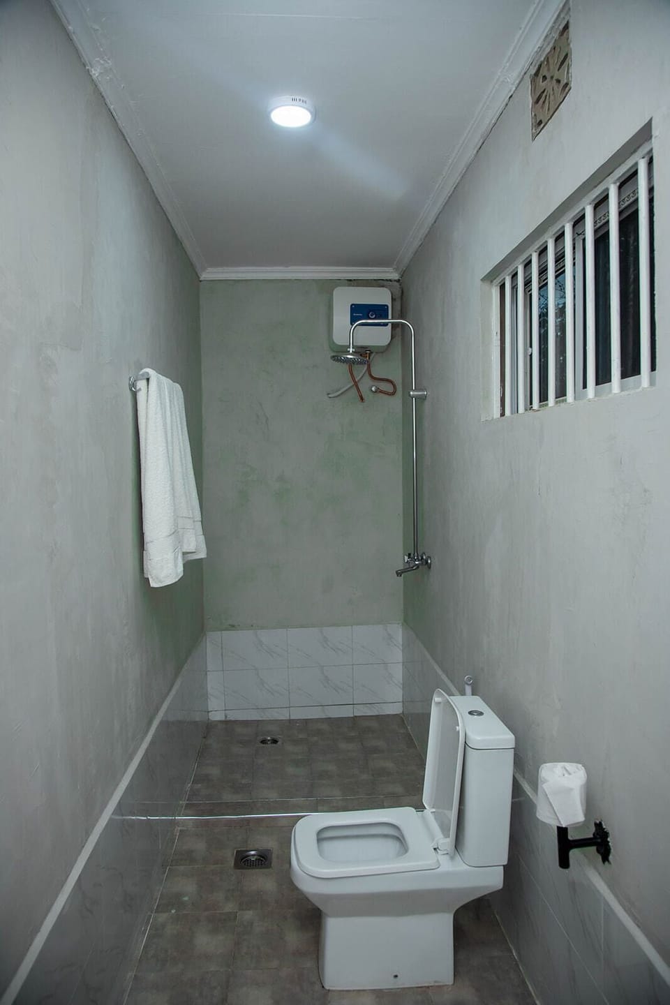 Family Triple Room | Bathroom | Shower, rainfall showerhead, slippers, towels