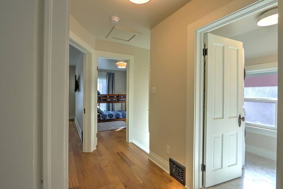Hallway to bedrooms and door into half bathroom