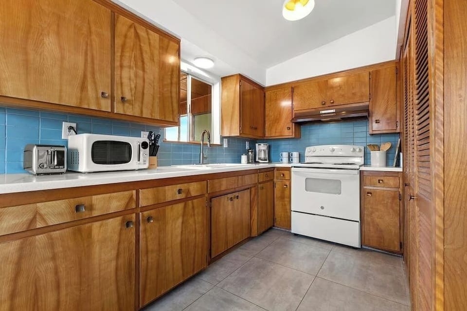 The kitchen is stocked with all of the comforts of home such as dishes, utensils, pots, pans, coffee maker, toaster, microwave, and basic cooking essentials like olive oil, salt and pepper.