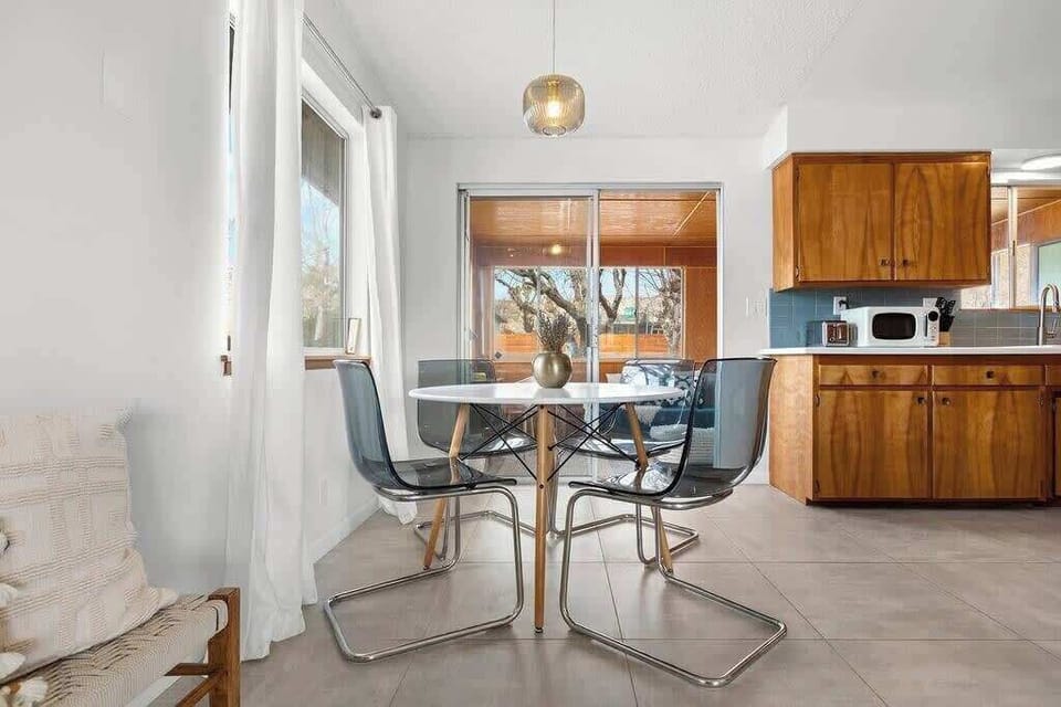 Right off of the living room you'll find the dining nook with a darling dining table for four