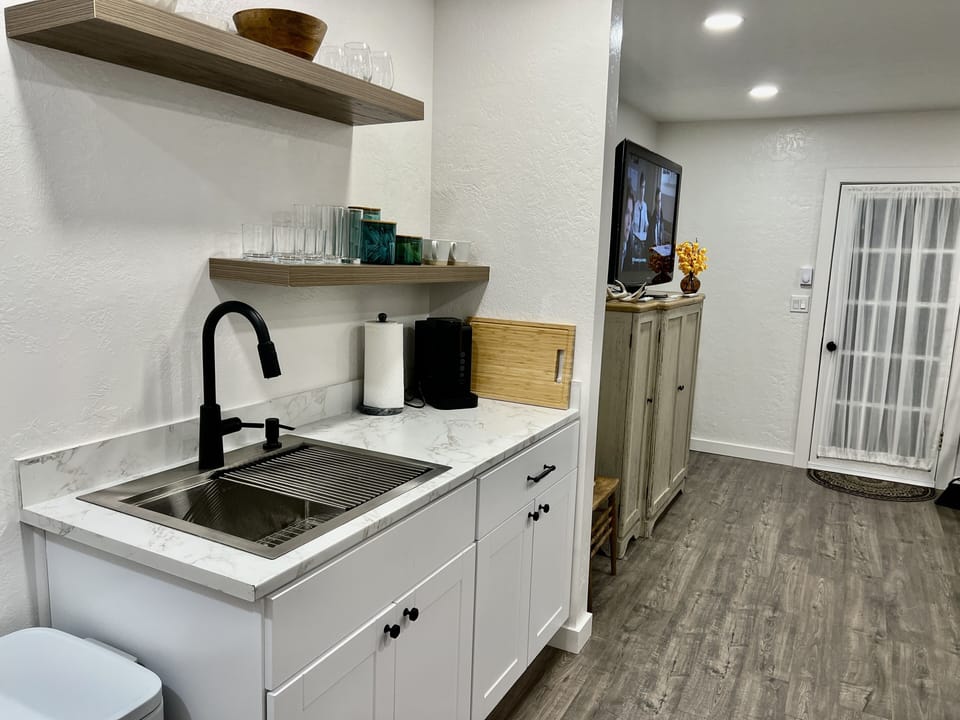 Kitchen and living room pictured.  Back door leading to fenced sunny yard.
