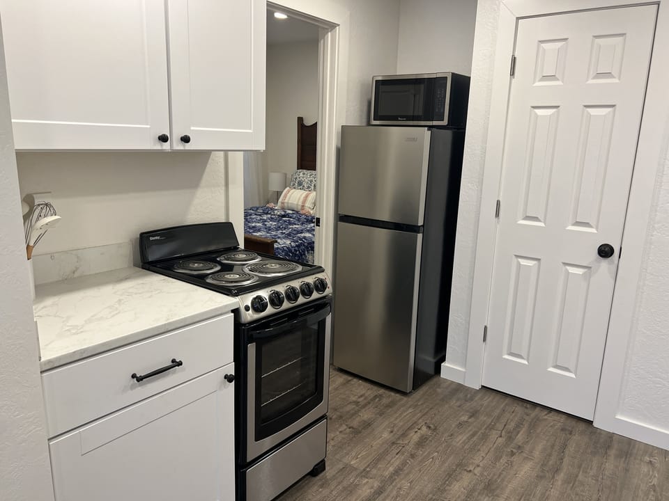 Kitchen with large apartment refrigerator.