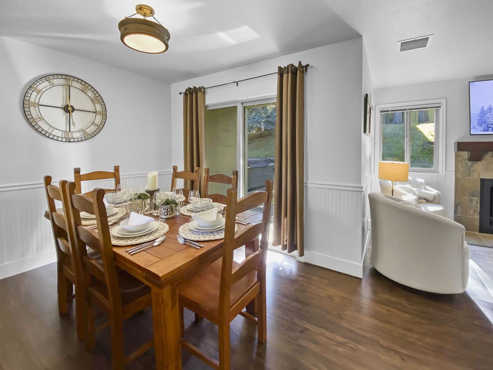 Relax in this mountain-modern open-concept retreat. Featuring a warm wooden dining table, handcrafted wood beams, and a cozy lounge area, it's the perfect hub for your Park City adventures.
