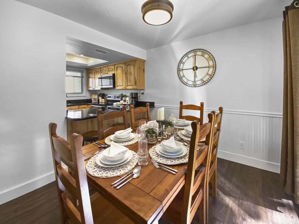 Relax in this mountain-modern open-concept retreat. Featuring a warm wooden dining table, handcrafted wood beams, and a cozy lounge area, it's the perfect hub for your Park City adventures.