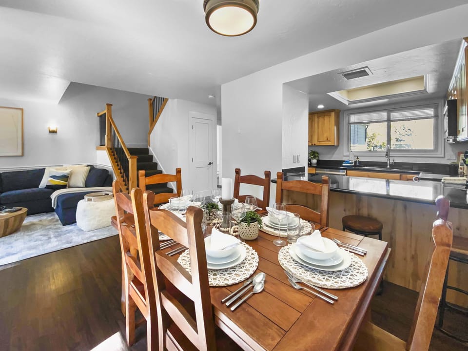 Relax in this mountain-modern open-concept retreat. Featuring a warm wooden dining table, handcrafted wood beams, and a cozy lounge area, it's the perfect hub for your Park City adventures.