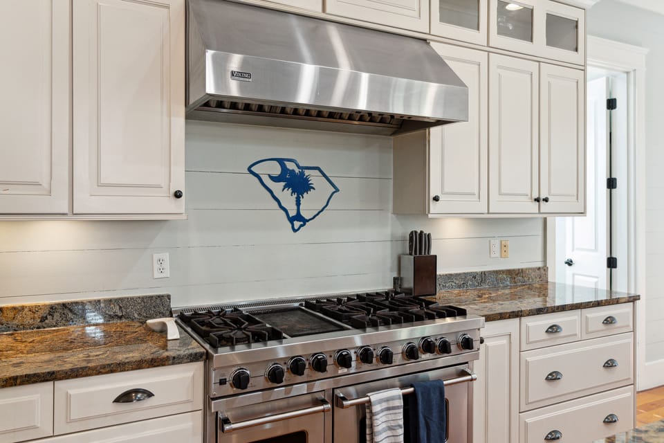 The kitchen is equipped with a 6 gas burners and a dual oven.
