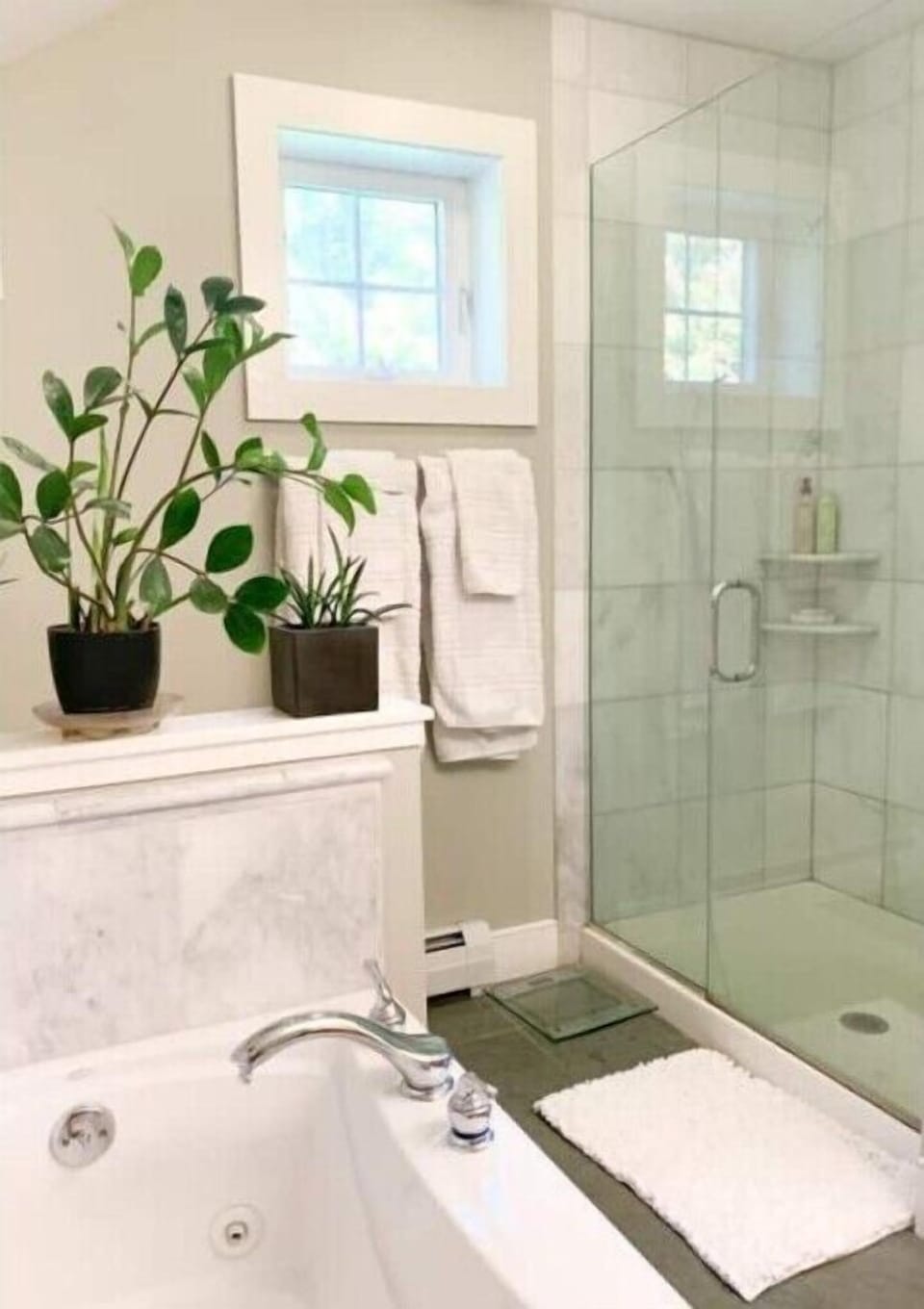 Jetted tub, marble shower, and slate floors in en suite bathroom
