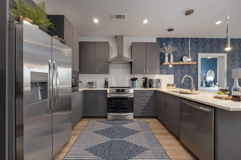 Fully equipped kitchen stocked with your basic cooking essentials, stainless-steel appliances, and breakfast bar seating.