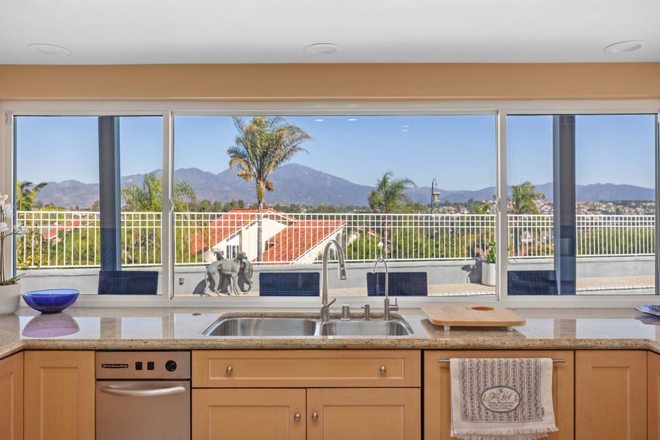 Kitchen with large window looking to pool and mountains