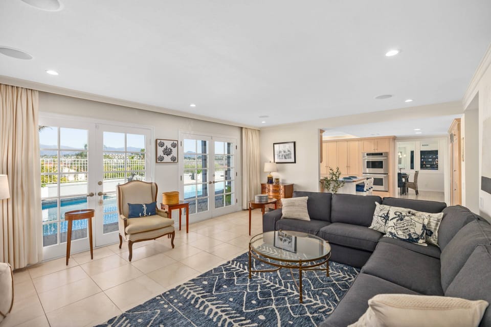 Family room opens to kitchen with french doors to back yard and pool