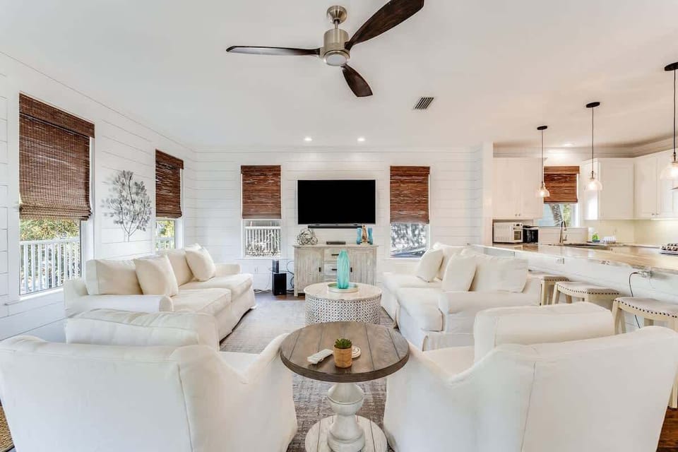 - Kick back in the cozy coastal living room, styled with plush seating and breezy charm - Natural light pours in through wood trimmed windows, warming every beachy detail - Perfect for laughter filled nights or a quiet morning coffee by the TV