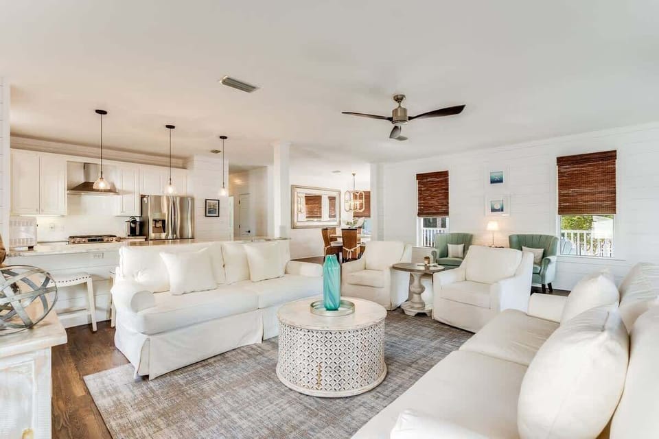 - Gather around in this coastal chic living room featuring plush seating and abundant natural light - Effortless entertaining with seamless flow from kitchen to living space - Thoughtful design brings comfort and charm to every cozy corner