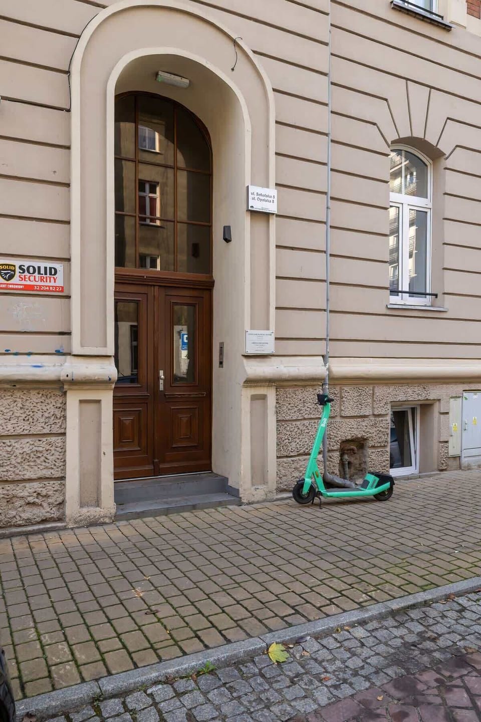 The main entrance to the building, featuring a traditional arched doorway and a small step leading inside.
