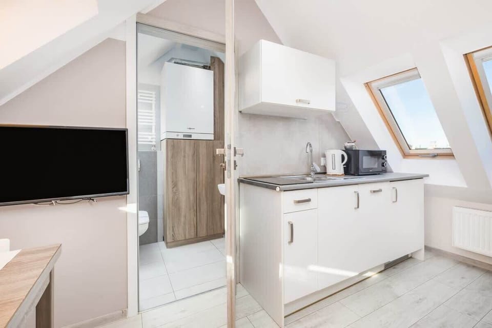 Another perspective of the attic kitchen, emphasizing its cozy yet functional layout.







