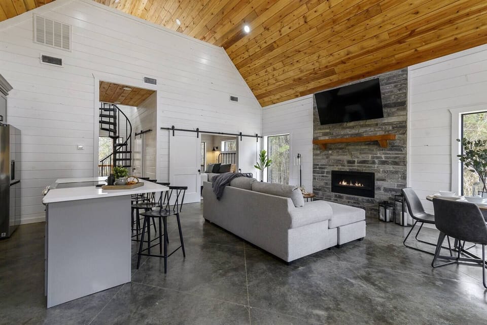 Warm wood tones, shiplap walls, and granite countertops create a modern living space