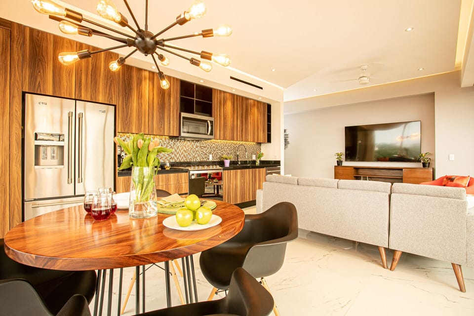 The dining table is conveniently located net to the kitchen