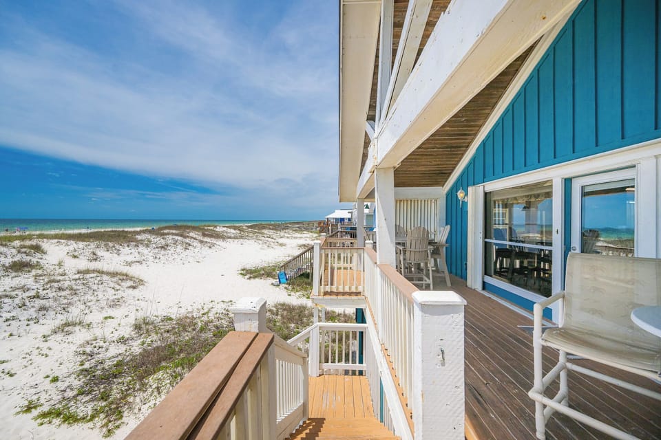 The spacious deck offers stunning beachfront views, perfect for relaxing or entertaining while enjoying the gentle sea breeze
