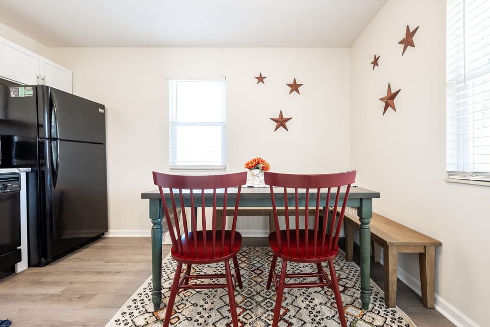 Dining area beside kitchen with 4 seats plus a bench seating