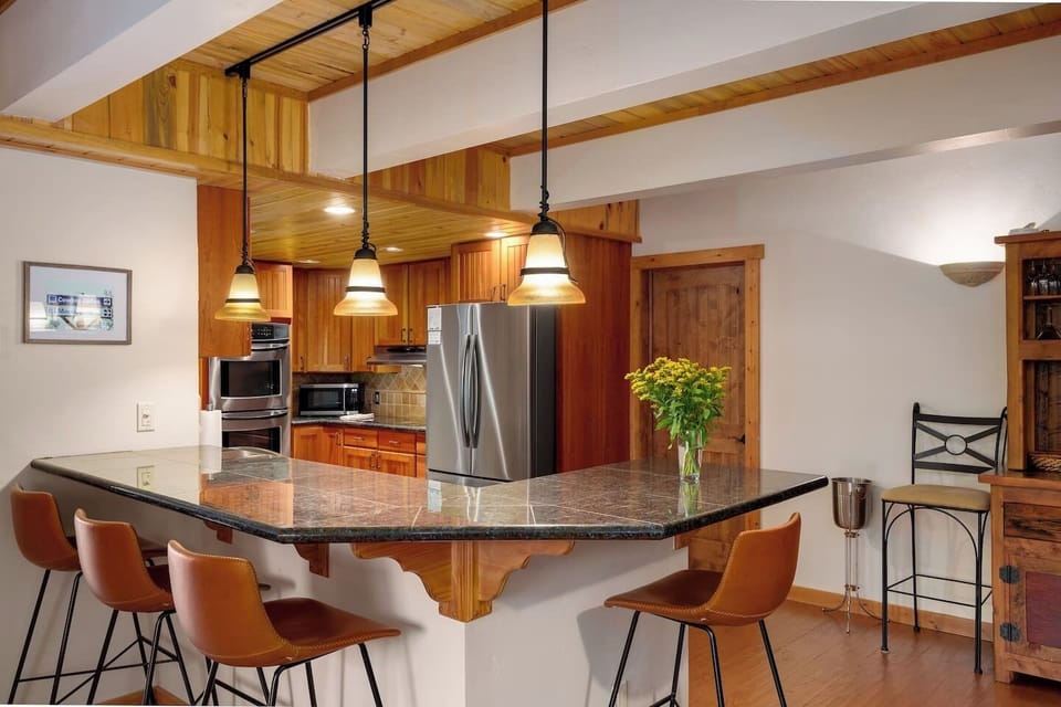 Gather around the spacious kitchen bar for breakfast, drinks, or conversation while meals are prepared.