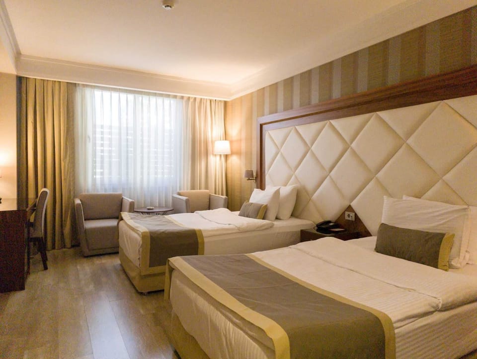 Standard Triple Room | Minibar, in-room safe, desk, soundproofing