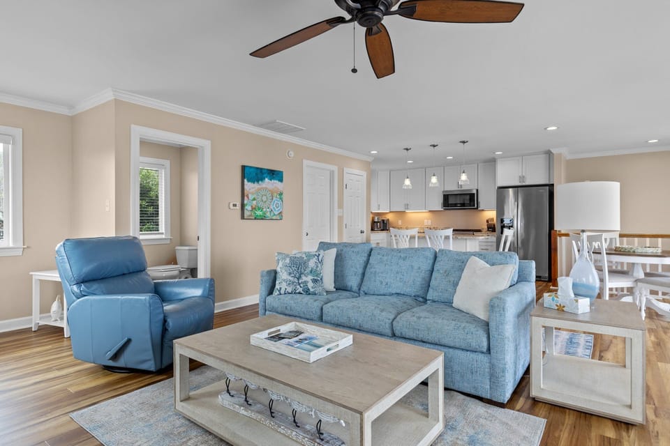 Your comfortable living space flows seamlessly into the modern kitchen, perfect for relaxing after beach days.