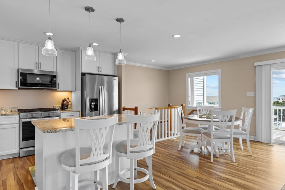 Your spacious kitchen features granite counters, stainless appliances, and pendant lighting, creating the perfect space for cooking memorable meals together.