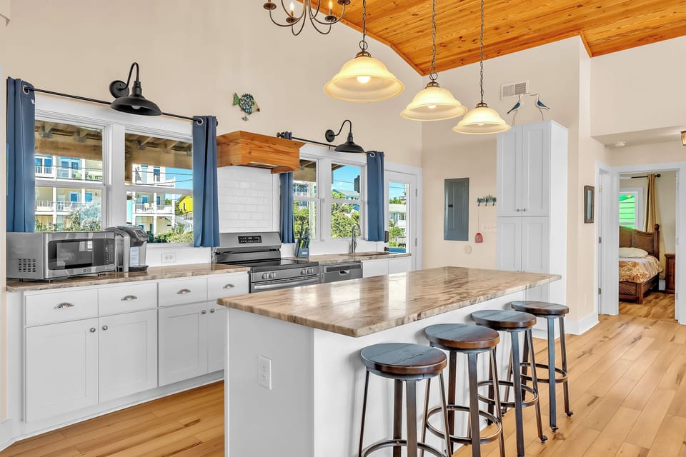 Your gourmet kitchen features a spacious island with bar seating, perfect for morning coffee or casual dining together.