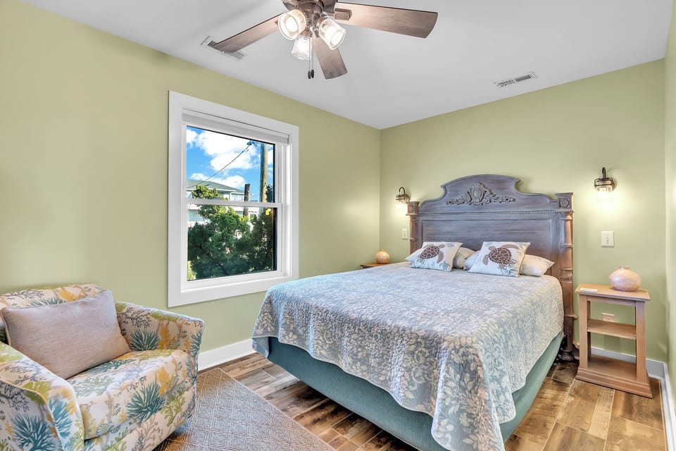 Unwind in your peaceful sanctuary with soft linens and gentle ceiling fan breezes keeping you comfortable all night long.