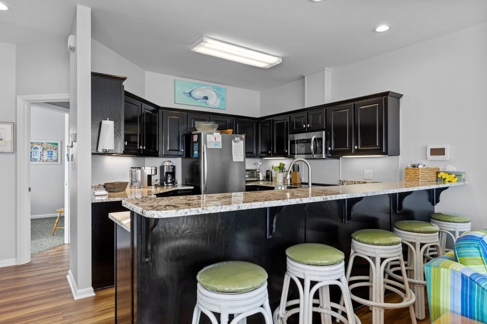 Your spacious kitchen features granite countertops, stainless appliances, and a breakfast bar where you can start each morning with coffee.