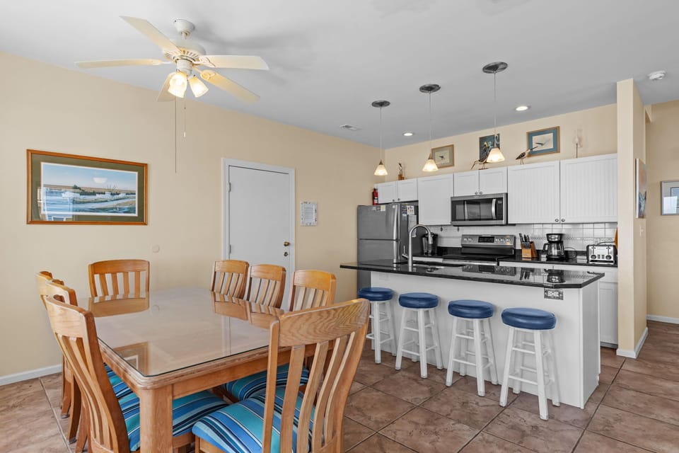 Your open-concept kitchen flows seamlessly into the dining area, perfect for cooking together and sharing meals with loved ones during your stay.