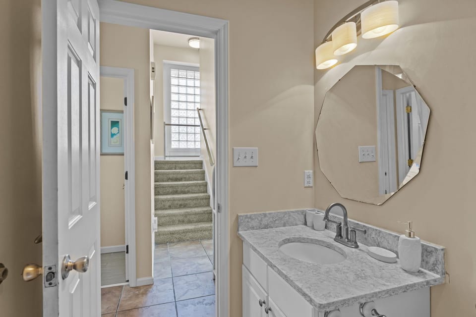 Step into your elegant powder room featuring marble countertops and warm lighting for a luxurious start to your day.