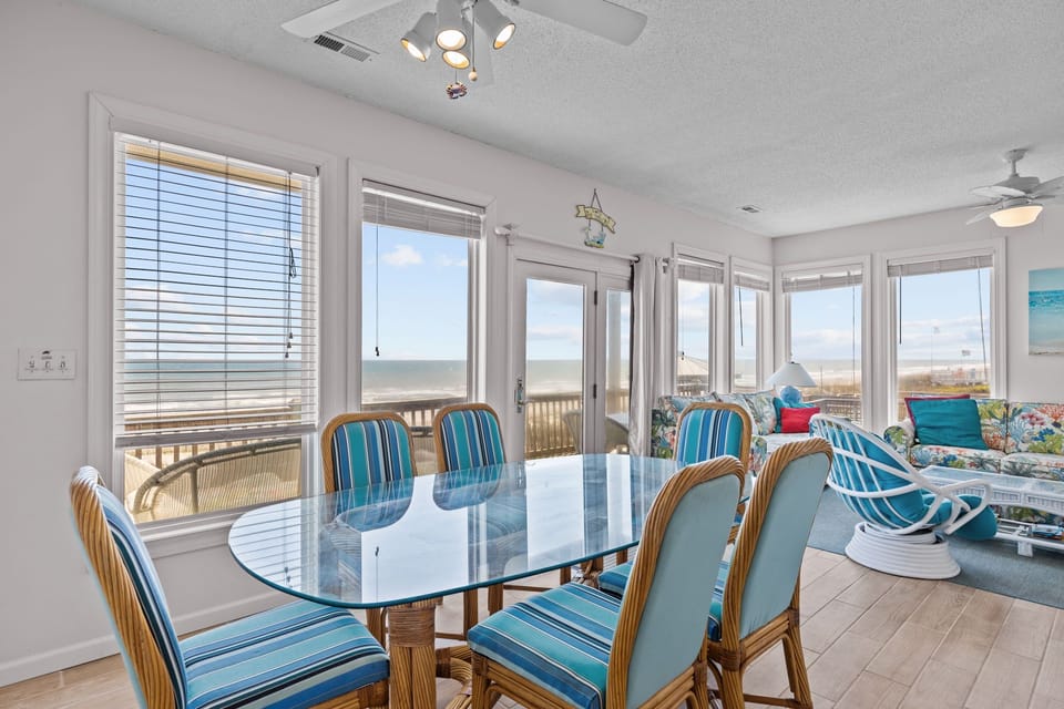 Your beachfront dining room offers stunning ocean views through floor-to-ceiling windows, creating the perfect backdrop for memorable meals.