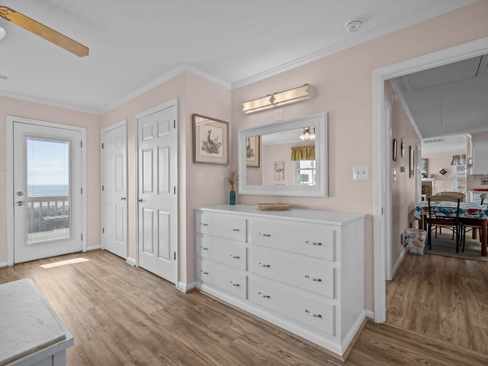 Your spacious hallway offers ample storage with built-in drawers and leads to your private balcony with stunning views.