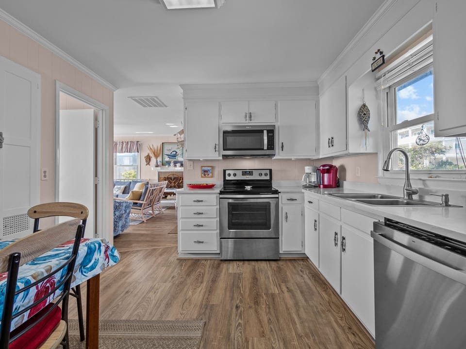 Your bright, fully equipped kitchen features modern appliances and coastal charm, perfect for preparing meals during your beach getaway.