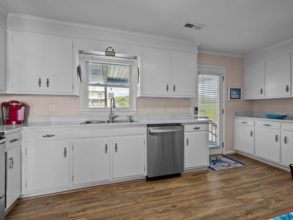 Your bright, fully equipped kitchen features crisp white cabinets, granite counters, and modern appliances for all your culinary adventures.
