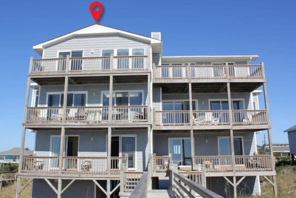 Multi-level beachfront property with expansive balconies and ocean access for your coastal getaway.