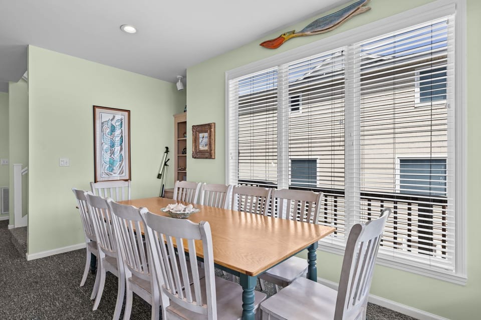 Gather around this spacious dining table where your group can share meals and create memories in the bright, welcoming space.