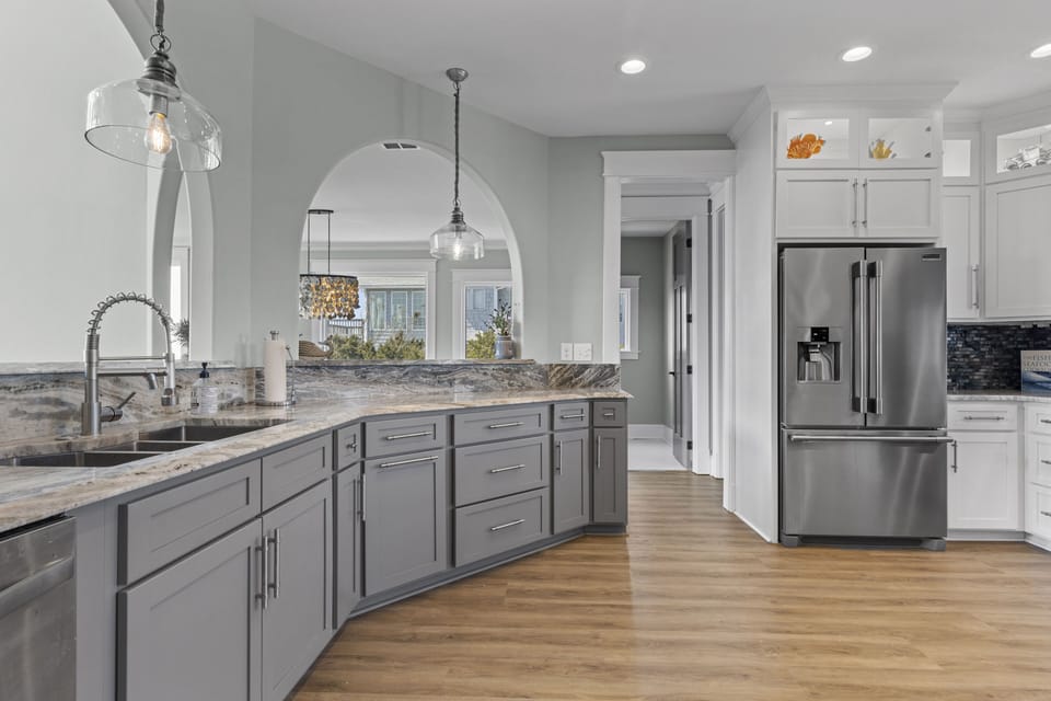 Your gourmet kitchen features gleaming countertops, modern appliances, and elegant lighting perfect for creating memorable meals together.
