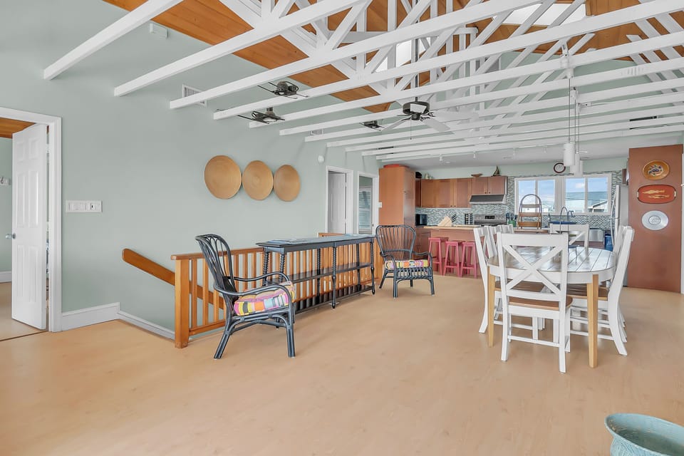 Relax in your bright, open living space with exposed beam ceilings and comfortable seating that flows seamlessly into the kitchen.