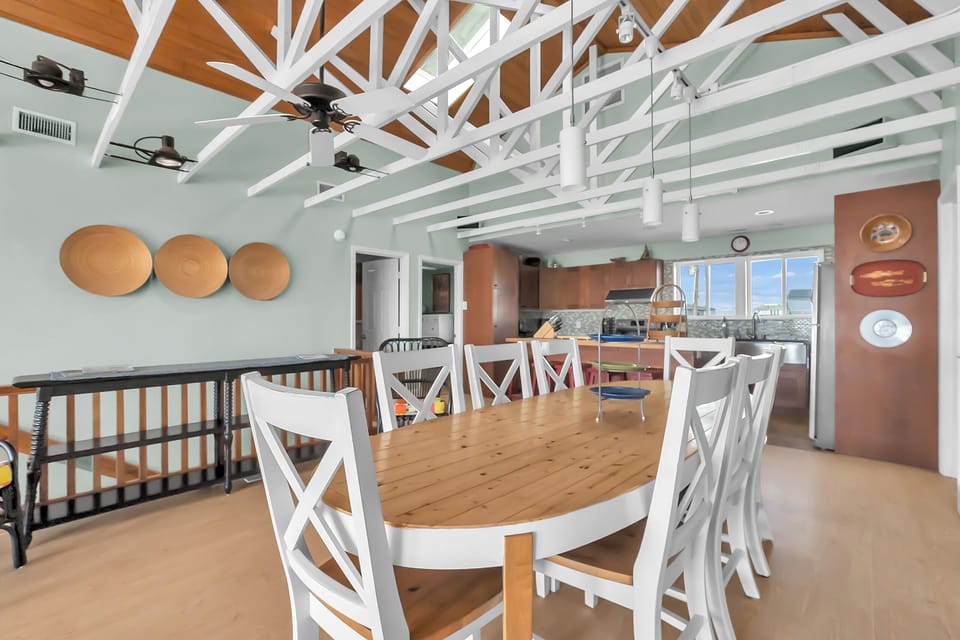 Your spacious dining area features exposed beam ceilings and flows seamlessly into a fully equipped kitchen, perfect for memorable meals together.