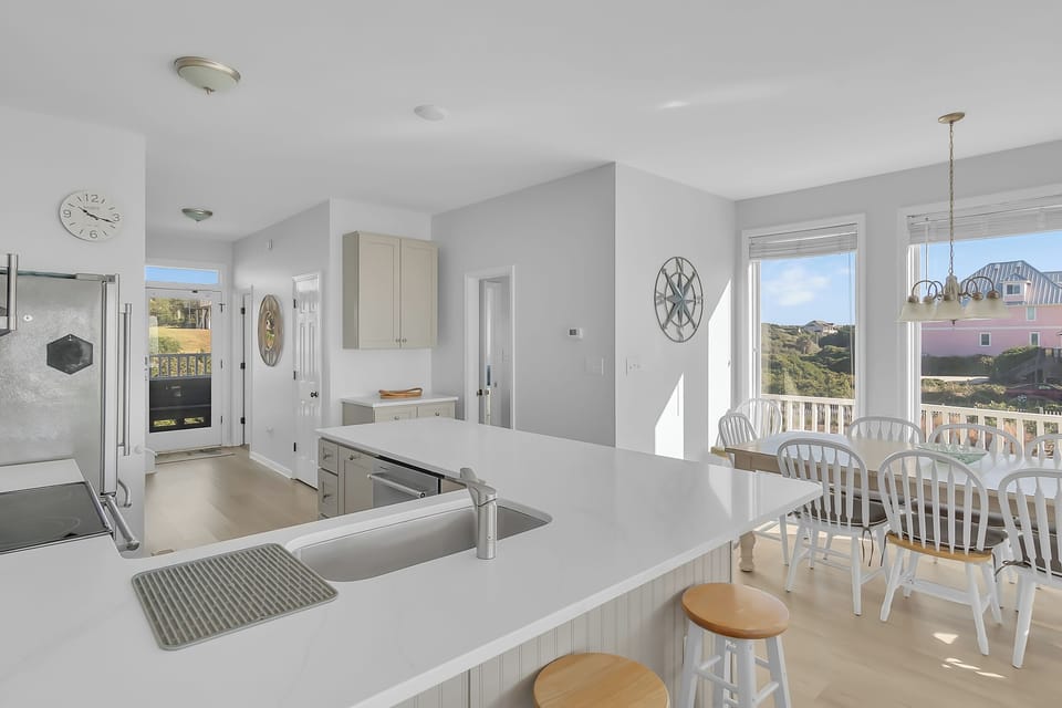 Cook while enjoying stunning views from your bright, modern kitchen with its spacious island and dining area bathed in natural light.