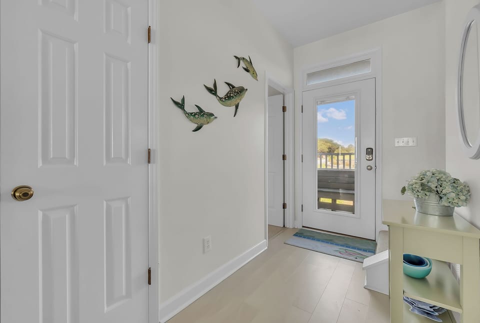 Step into your bright, welcoming entryway where charming bird art and fresh touches create an instant sense of home.