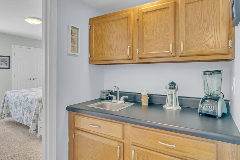 Your kitchenette features warm oak cabinets, a handy blender, and everything you need for light meal prep during your stay.