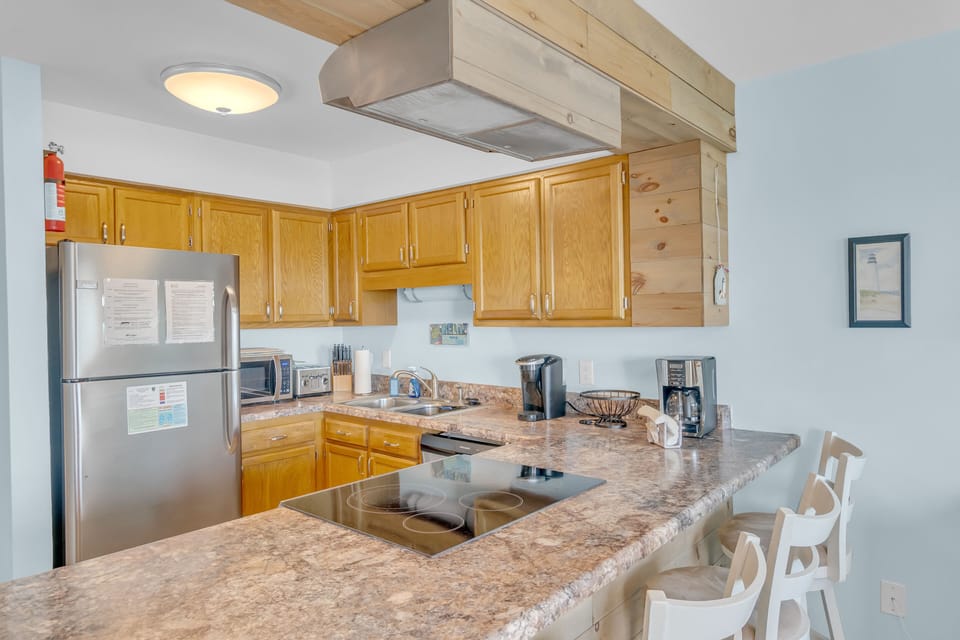 Your fully-equipped kitchen invites culinary adventures with granite countertops, modern appliances, and breakfast bar seating for casual dining.