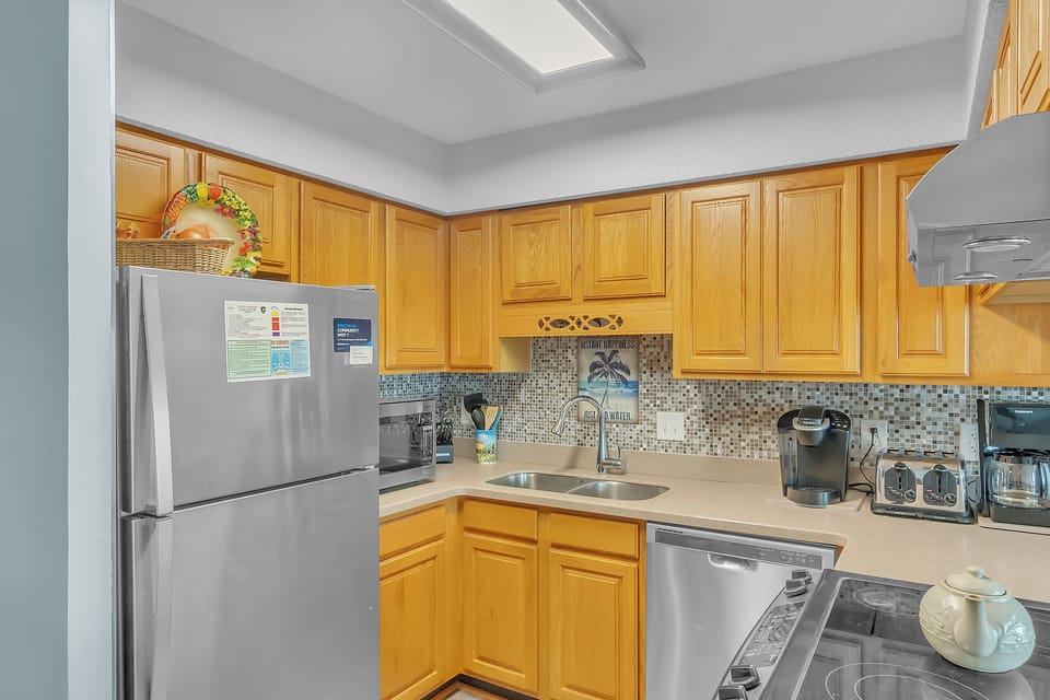 Your fully equipped kitchen features warm wood cabinets, modern appliances, and everything you need to cook memorable meals during your stay.